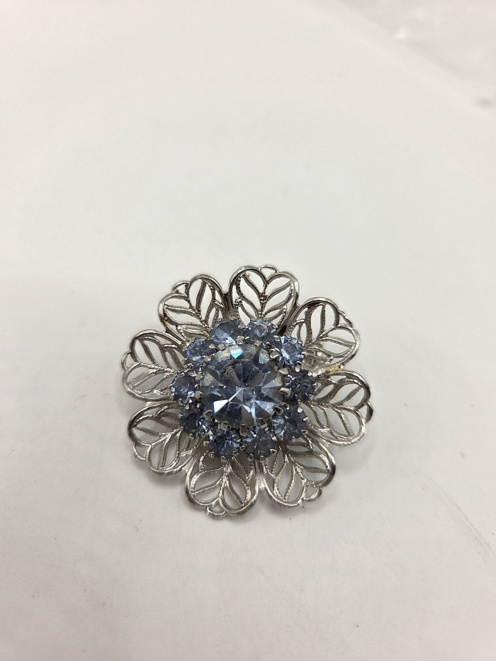 1712. Vintage Silver-Tone Floral Brooch with Light Blue Crystal Center